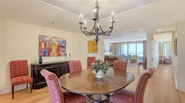 dining area featuring baseboards, a notable chandelier, and light wood-style flooring