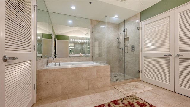 full bath featuring a shower stall, a bath, recessed lighting, and tile patterned floors