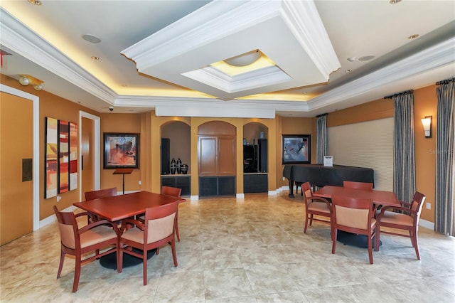 dining area featuring arched walkways, a raised ceiling, baseboards, and ornamental molding