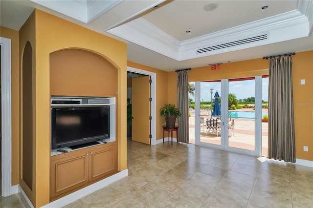 living room featuring visible vents, ornamental molding, a tray ceiling, french doors, and baseboards