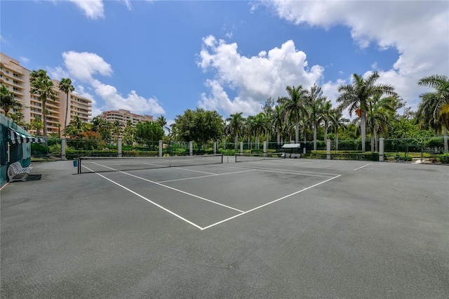 view of tennis court featuring fence