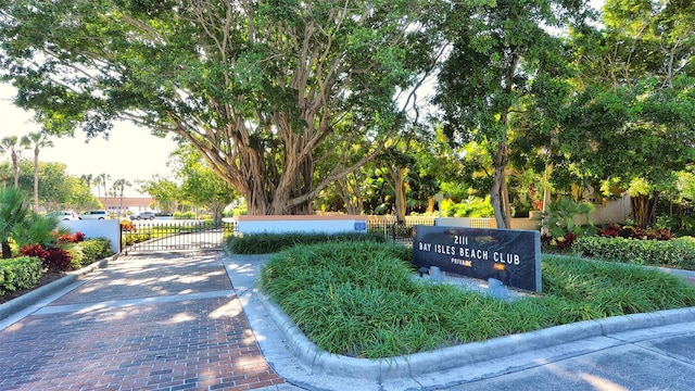 view of home's community featuring a gate and fence