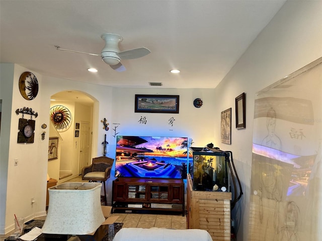 tiled living area with recessed lighting, visible vents, arched walkways, and ceiling fan