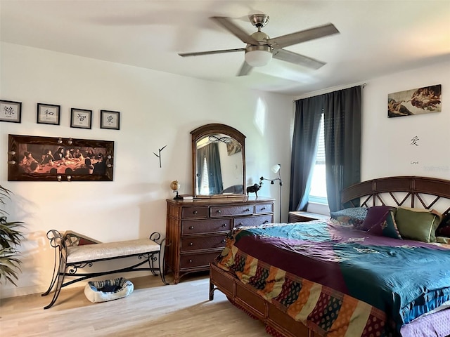 bedroom with a ceiling fan and wood finished floors