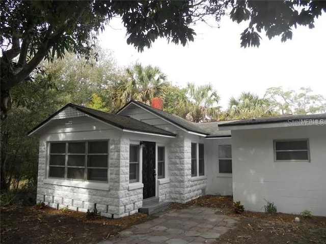 775 36th Ave S, Saint Petersburg, FL 33705 - rear view of property with a chimney