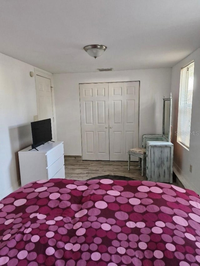775 36th Ave S, Saint Petersburg, FL 33705 - unfurnished bedroom with a closet and wood finished floors