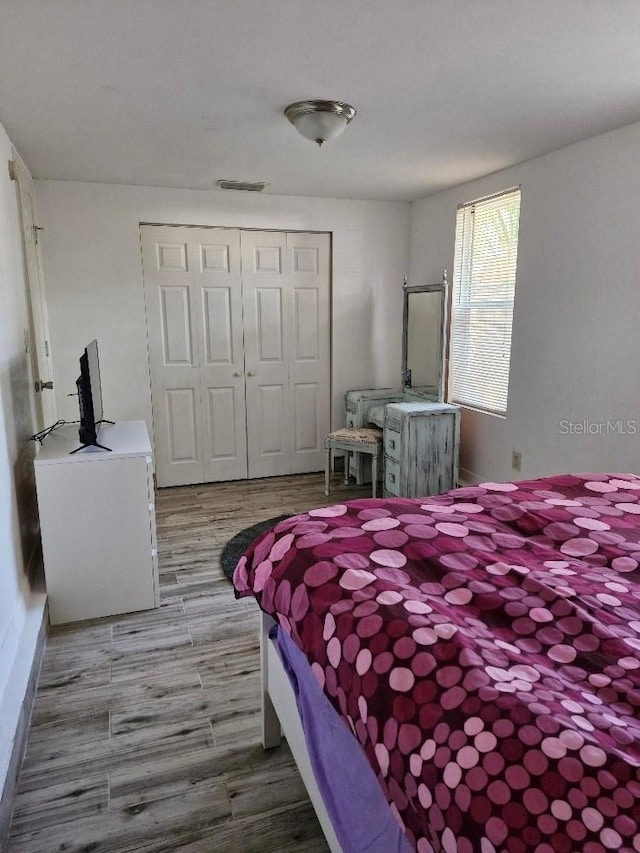 775 36th Ave S, Saint Petersburg, FL 33705 - bedroom with a closet, wood finished floors, and visible vents