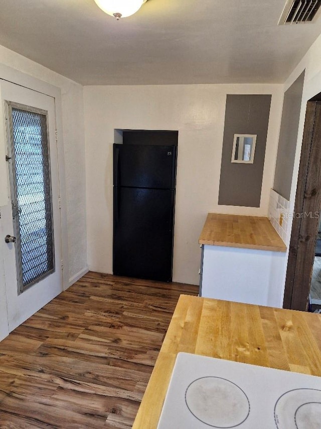 775 36th Ave S, Saint Petersburg, FL 33705 - kitchen with visible vents, wooden counters, wood finished floors, and freestanding refrigerator