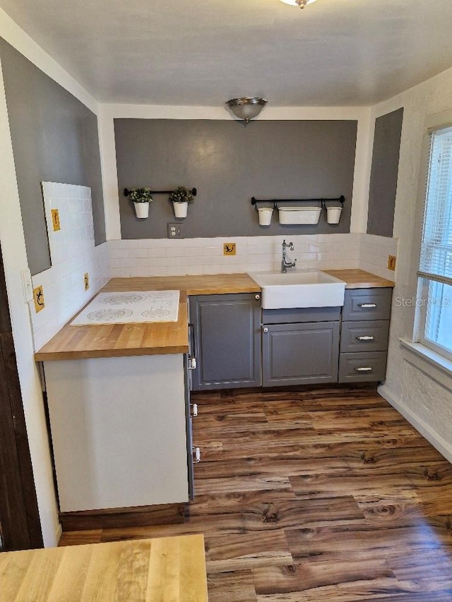 775 36th Ave S, Saint Petersburg, FL 33705 - kitchen with wood counters, decorative backsplash, gray cabinets, and a sink