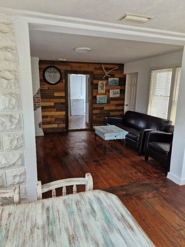 775 36th Ave S, Saint Petersburg, FL 33705 - unfurnished living room with visible vents, wooden walls, washer / clothes dryer, and wood finished floors