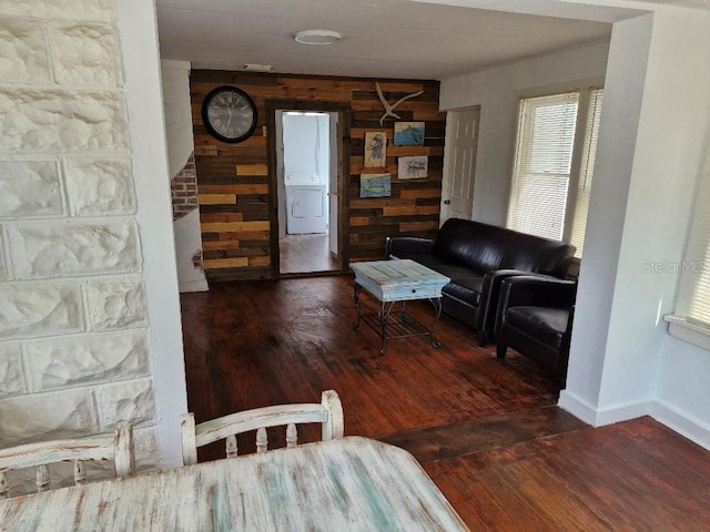 775 36th Ave S, Saint Petersburg, FL 33705 - living room featuring washer / dryer, baseboards, and wood finished floors