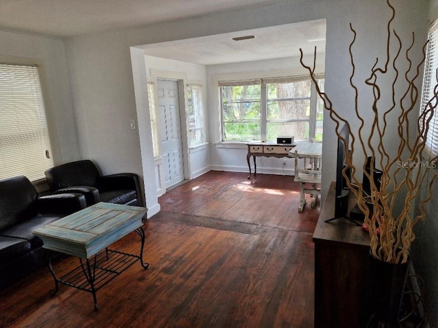 775 36th Ave S, Saint Petersburg, FL 33705 - living room with baseboards and dark wood-type flooring