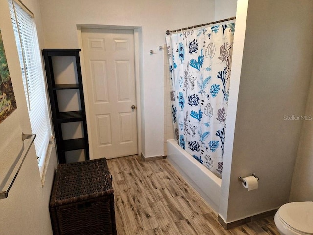 775 36th Ave S, Saint Petersburg, FL 33705 - bathroom featuring shower / bath combination with curtain, wood finished floors, toilet, and baseboards
