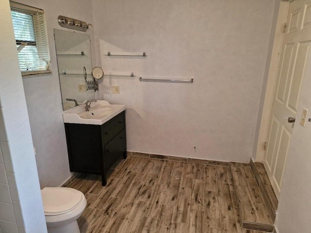 775 36th Ave S, Saint Petersburg, FL 33705 - bathroom with vanity, toilet, and wood finished floors