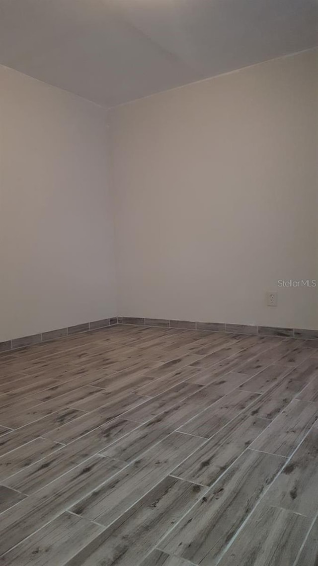 775 36th Ave S, Saint Petersburg, FL 33705 - empty room with baseboards and wood finished floors