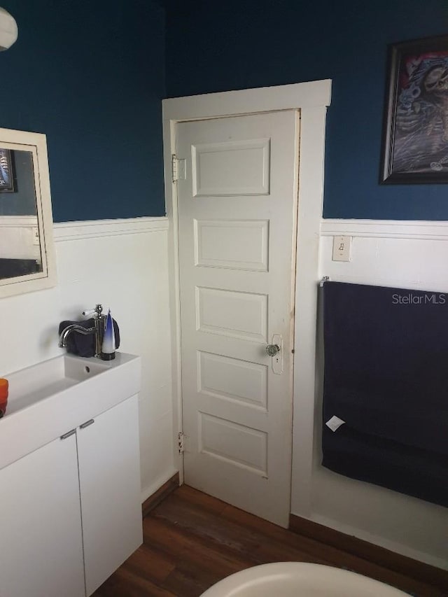 775 36th Ave S, Saint Petersburg, FL 33705 - bathroom featuring wood finished floors, wainscoting, and a sink