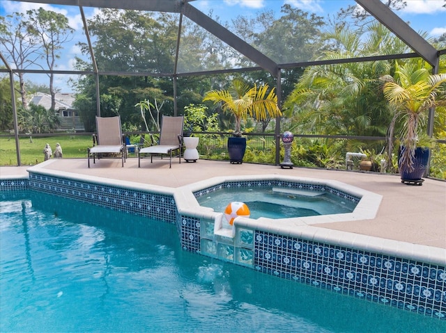 view of swimming pool featuring a pool with connected hot tub, a patio area, and a lanai