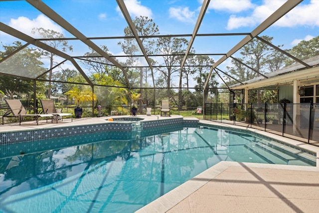 pool with a lanai, an in ground hot tub, and a patio