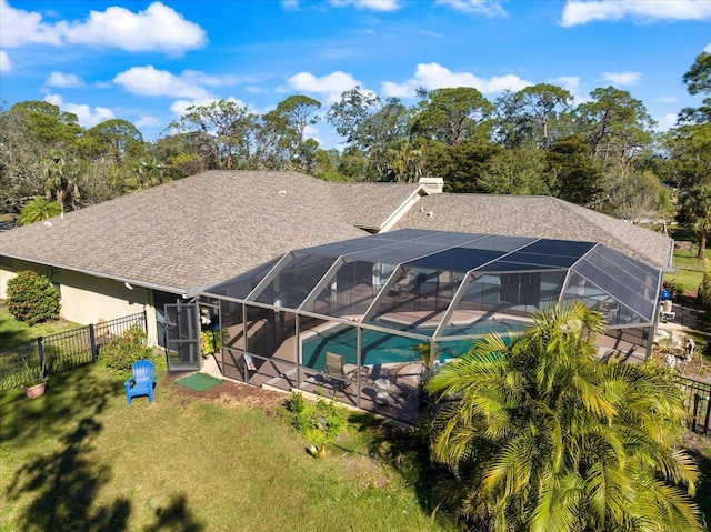 rear view of house featuring a patio, a chimney, fence, a lanai, and an outdoor pool