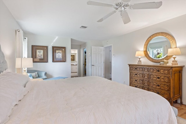 bedroom featuring connected bathroom, visible vents, and a ceiling fan