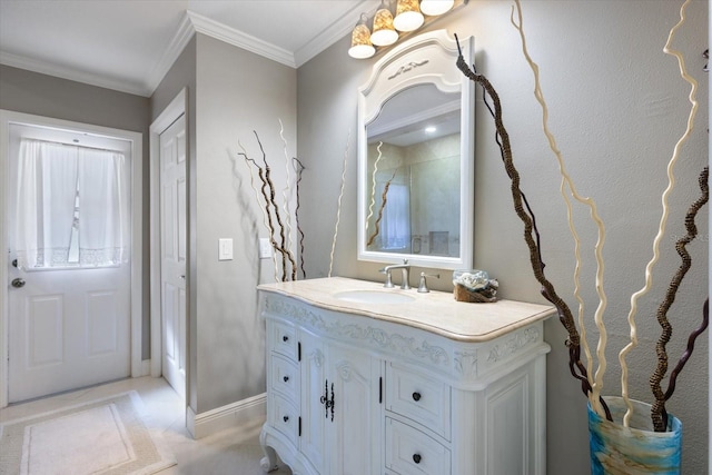 bathroom featuring baseboards, vanity, and crown molding