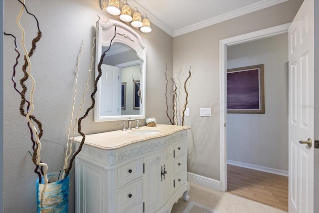 bathroom with tile patterned flooring, baseboards, crown molding, and vanity