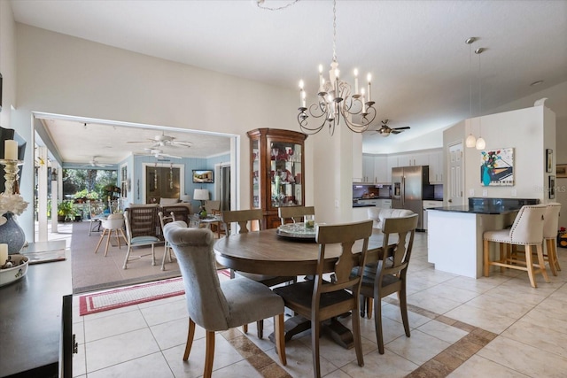 dining room with light tile patterned floors and ceiling fan with notable chandelier