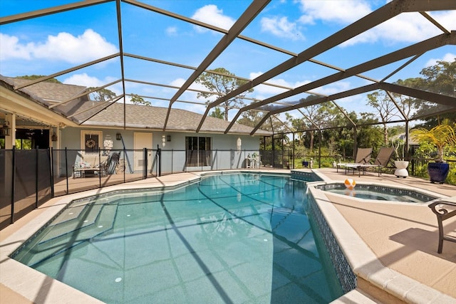 view of swimming pool with a lanai, a patio area, and a pool with connected hot tub