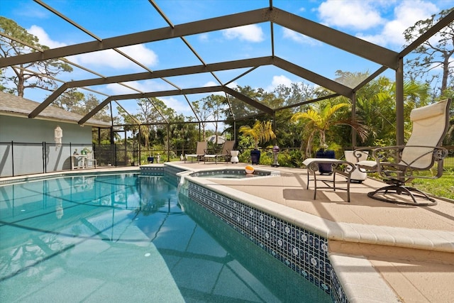 view of swimming pool featuring a lanai, a pool with connected hot tub, and a patio