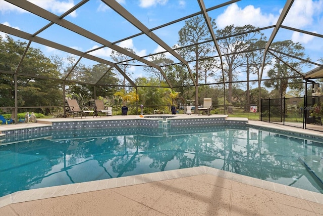 view of swimming pool featuring a lanai, a pool with connected hot tub, and a patio