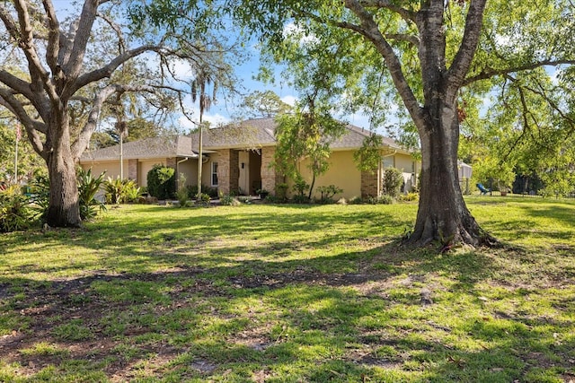 single story home with a front yard and an attached garage