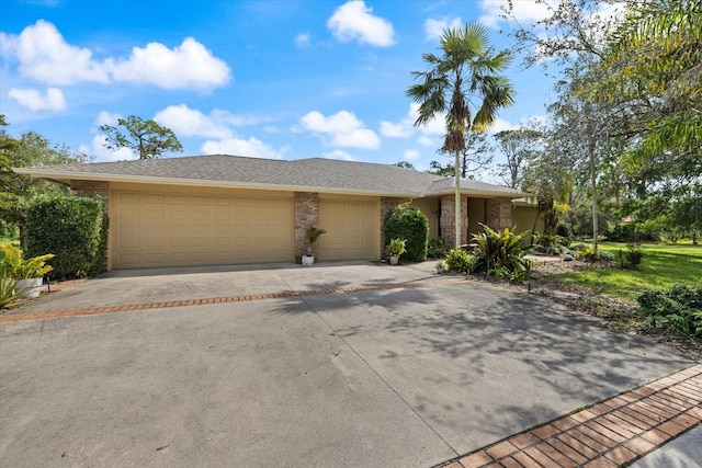 view of front of property with brick siding, driveway, and an attached garage