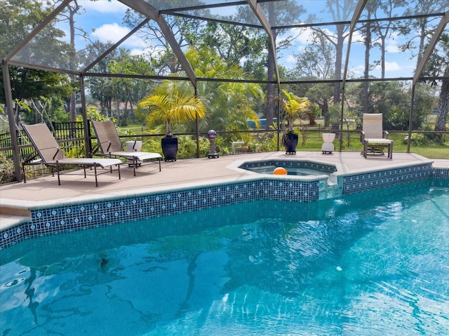 outdoor pool featuring a lanai, a patio area, and an in ground hot tub