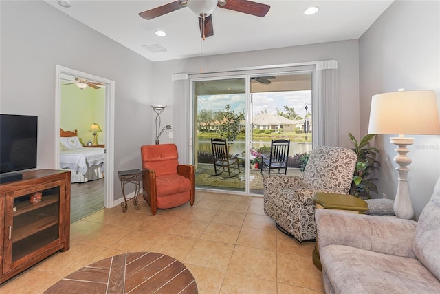 living area featuring light tile patterned floors, ceiling fan, baseboards, and recessed lighting