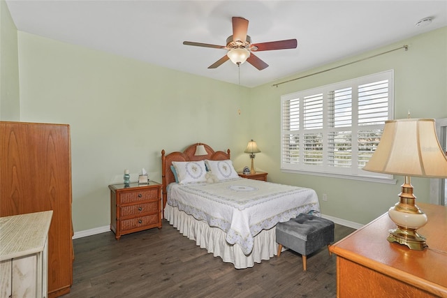 bedroom featuring dark wood-style floors, baseboards, and a ceiling fan