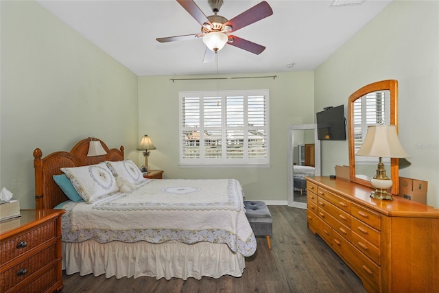 bedroom featuring a ceiling fan, baseboards, and dark wood-type flooring