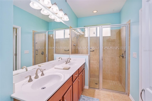 bathroom with plenty of natural light, a sink, tile patterned flooring, and a shower stall