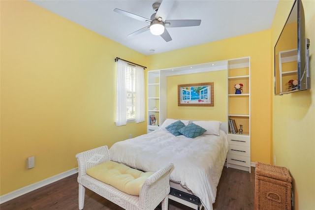 bedroom featuring a ceiling fan, dark wood-style flooring, and baseboards