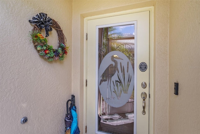 doorway to property with stucco siding