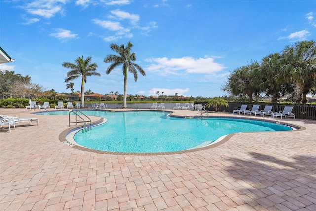 pool featuring a patio and fence