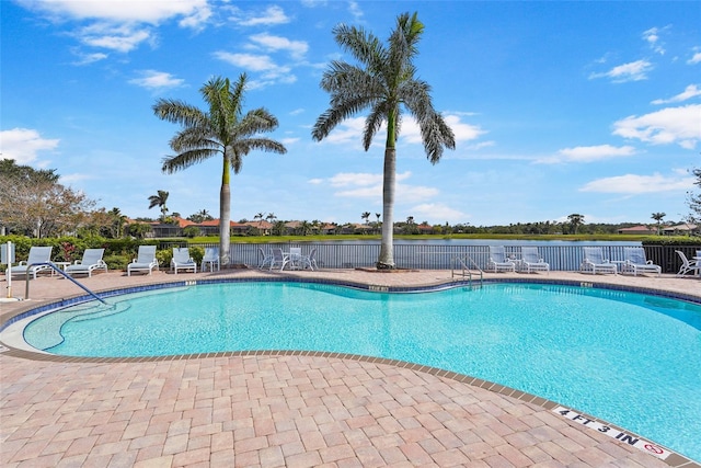 pool featuring fence and a patio