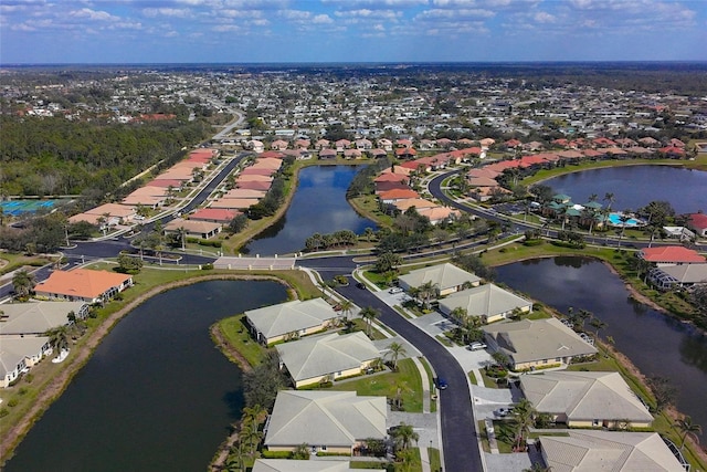 bird's eye view featuring a residential view and a water view