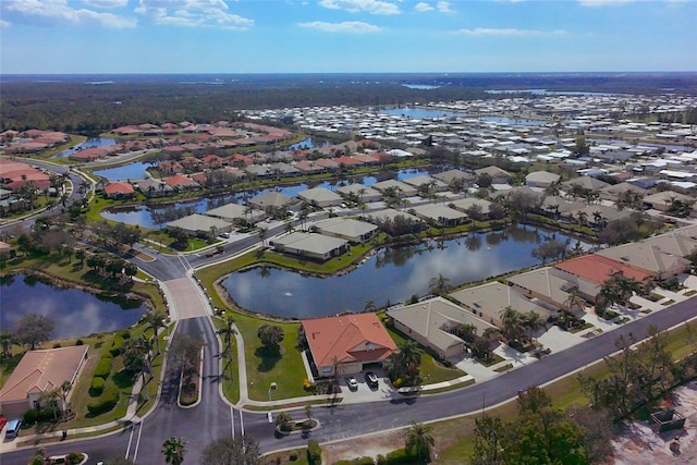 drone / aerial view with a water view and a residential view