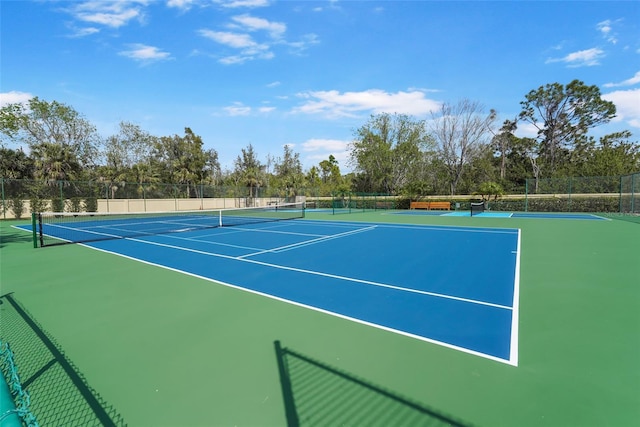 view of sport court featuring fence