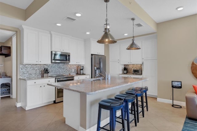 kitchen featuring visible vents, appliances with stainless steel finishes, and light tile patterned flooring