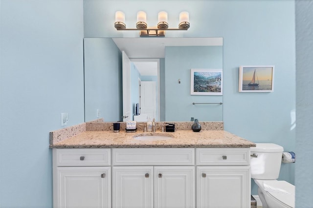 bathroom featuring toilet and vanity