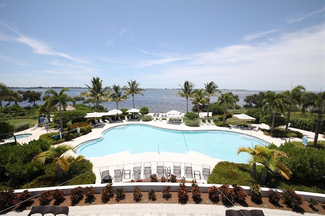 community pool featuring a water view and a patio