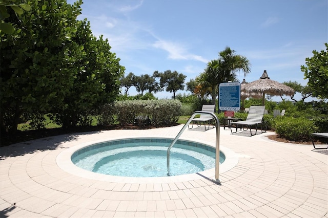 view of pool featuring a community hot tub and a patio