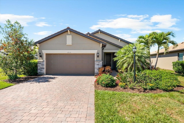 view of front of property with a garage, stone siding, decorative driveway, and stucco siding