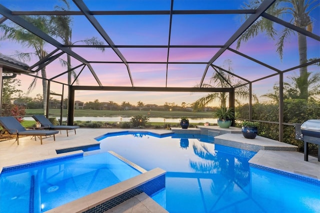 view of swimming pool with grilling area, glass enclosure, a pool with connected hot tub, and a patio